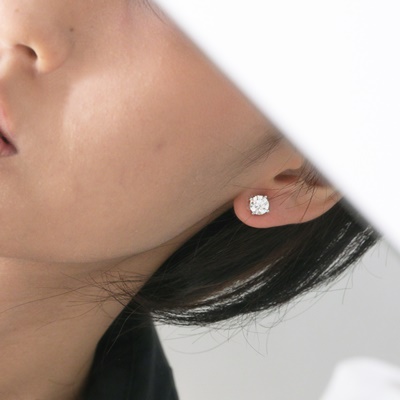 diamond stud earrings on womans ears