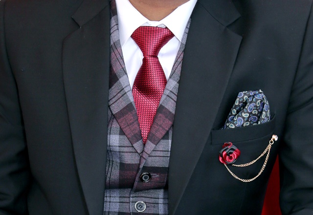 man wearing black notched lapel suit jacket