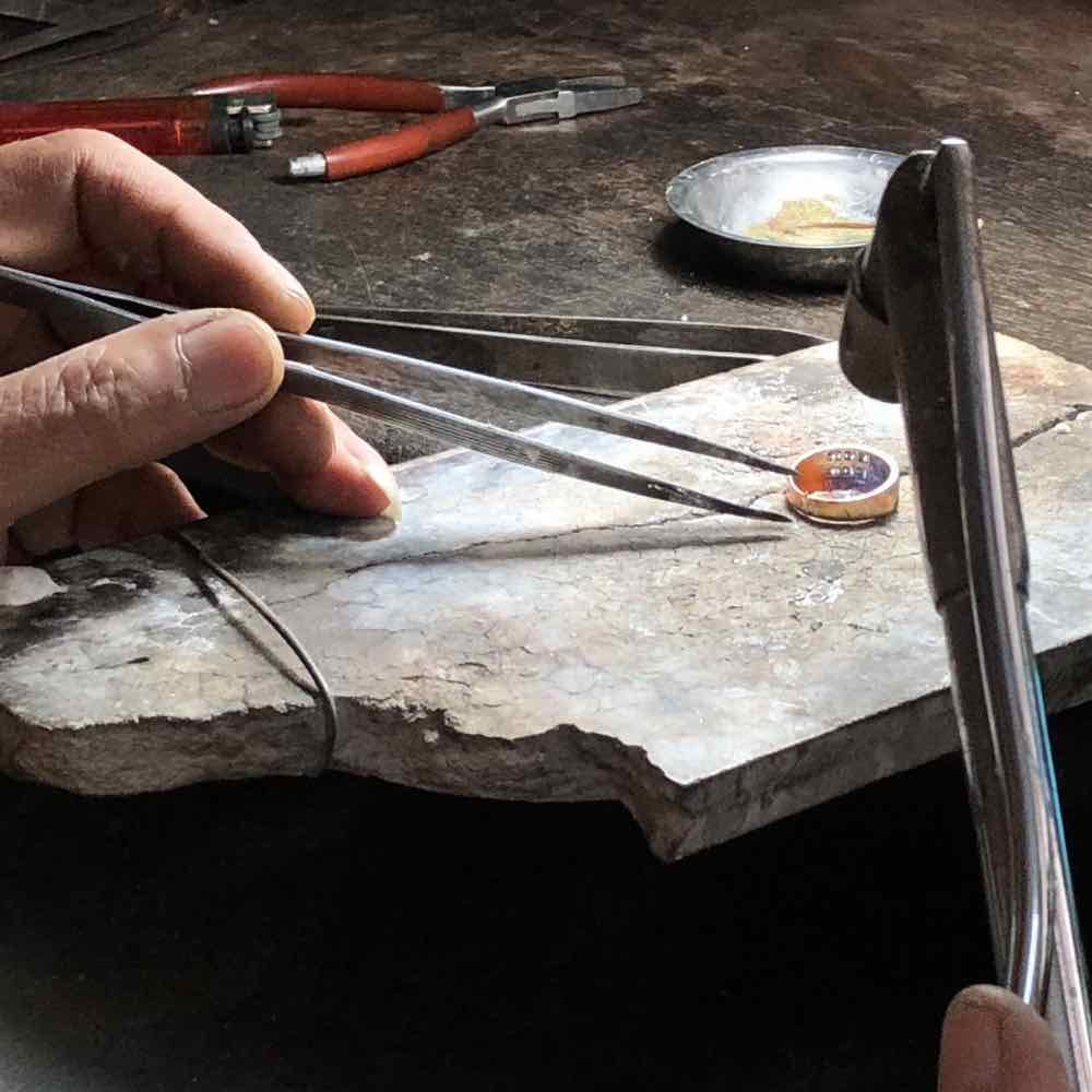 artisan working on diamond ring setting